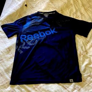 Dark blue Reebok moisture wicking to keep you dry through your athletic day !!